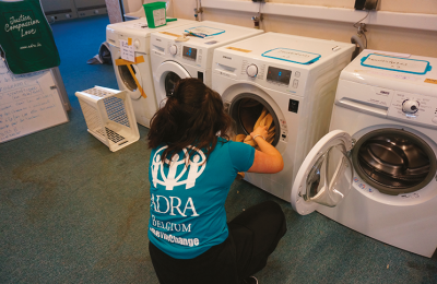 23- ADRA Volunteer at the Laundry in the refugees center